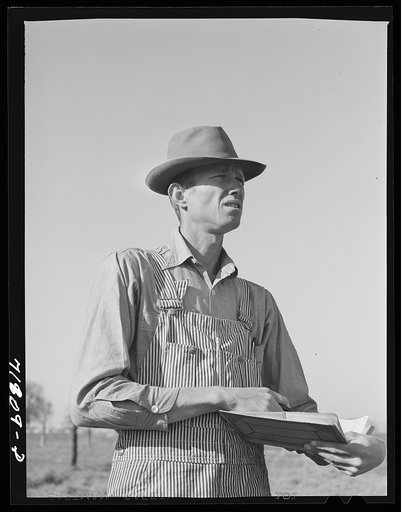 Woodville, California. FSA (Farm Security Administration) farm workers' community. Checking cotton pickers. He is a resident of the community