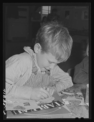 Woodville, California. FSA (Farm Security Administration) farm workers' community. Schoolchild making a valentine
