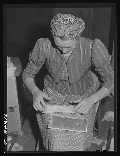 Woodville, California. FSA (Farm Security Administration) farm workers' community. Carding surplus cotton to be used for quilts