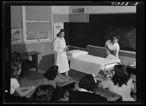 Eleven Mile Corner, Arizona. FSA (Farm Security Administration) farm workers' community. The nurse, who divides her time between work at the hospital and NYA instruction, teaching girls who live at the NYA resident center how to make a bed properly