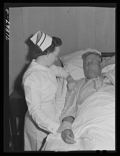 Eleven Mile Corner, Arizona. Cairns General Hospital. FSA (Farm Security Administration) farm workers' community. Nurse taking temperature of a patient