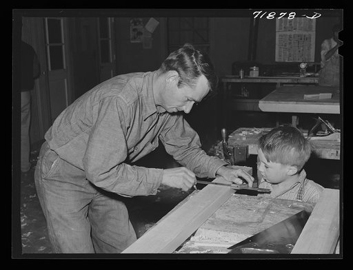 Eleven Mile Corner, Arizona. FSA (Farm Security Administration) farm workers' community. Agricultural worker and his son in the workshop