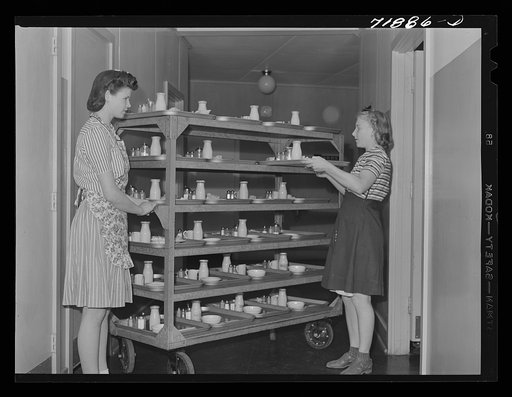 NYA (National Youth Association) girls deliver the trays at lunchtime at the Cairns General Hospital at the FSA (Farm Security Administration) farm workers' community. Eleven Mile Corner, Arizona. These NYA girls live at the resident center at the FSA camp and receive training as nurses' helpers