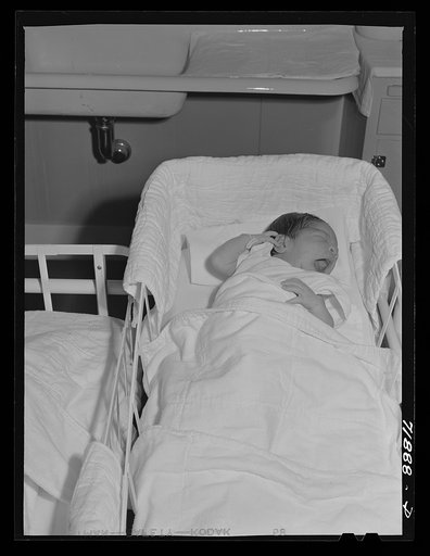 Baby in the nursey at the Cairns General Hospital at the FSA (Farm Security Administration) farm workers' community. Eleven Mile Corner, Arizona