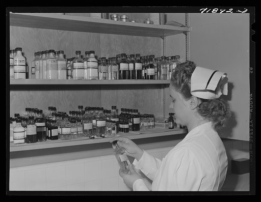 Eleven Mile Corner, Arizona. Cairns General Hospital, FSA (Farm Security Administration) farm workers' community. Nurse getting medicine from the storeroom