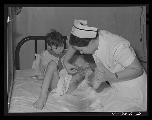 Eleven Mile Corner, Arizona. Cairns General Hospital, FSA (Farm Security Administration) farm workers' community. Nurse removing a patient's bandage