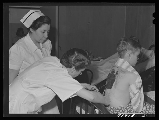 Eleven Mile Corner, Arizona. Cairns General Hospital, FSA (Farm Security Administration) farm workers' community. Resident doctor dressing a burn