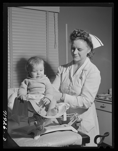Nurse weighs baby at the well baby clinic at the Cairns General Hospital at the FSA (Farm Security Administration) farm workers' community. Eleven Mile Corner, Arizona