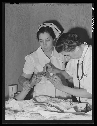 Eleven Mile Corner, Arizona. Cairns General Hospital, FSA (Farm Security Administration) farm workers' community. Resident doctor and nurse attending a patient