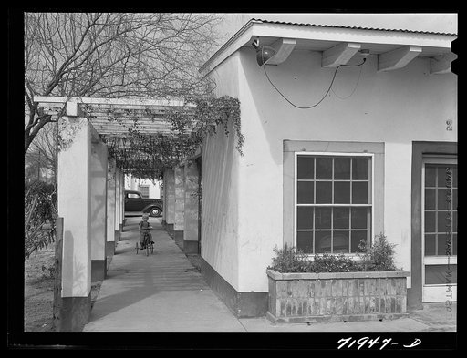 Phoenix, Arizona. Camelback Farms, FSA (Farm Security Administration) project. Open passageway of the community building