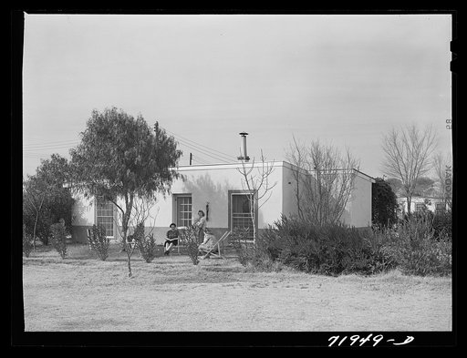 Neighbors meet at one of the houses at Camelback Farms, a FSA (Farm Security Administration) project at Phoenix, Arizona