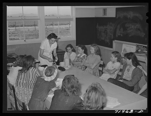 Eleven Mile Corner, Arizona. FSA (Farm Security Administration) farm workers' community. Home economics teacher demonstrating to schoolgirls the proper methods of preparing various foods