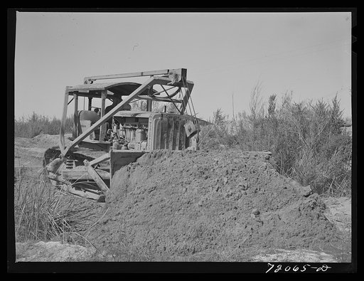 Bulldozer works on irrigation ditch. Imperial County, California