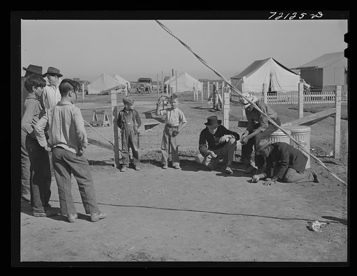 Boys play marbles at the FSA (Farm Security Administration) farm workers' community. Friendly Corners, Arizona