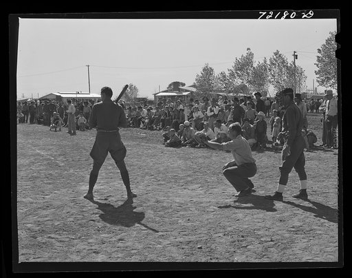 Boys from nearby Army camp play baseball at the field day at the FSA (Farm Security Administration) farm workers' community. Yuma, Arizona