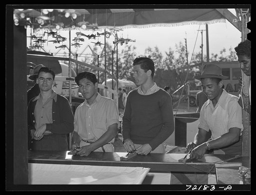 Untitled photo, possibly related to: Boys at carnival attraction. Imperial County Fair, California
