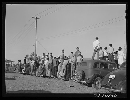 Farm workers watch athletic events at the second annual field day  at the FSA (Farm Security Administration) farm workers' community. Yuma, Arizona