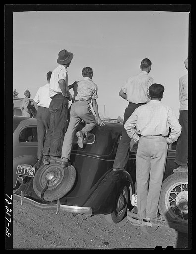 Farm workers watch athletic events at the second annual field day  at the FSA (Farm Security Administration) farm workers' community. Yuma, Arizona