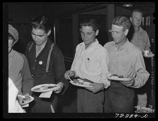 Farm workers at dinner at the second annual field day  at the FSA (Farm Security Administration) farm workers' community. Yuma, Arizona