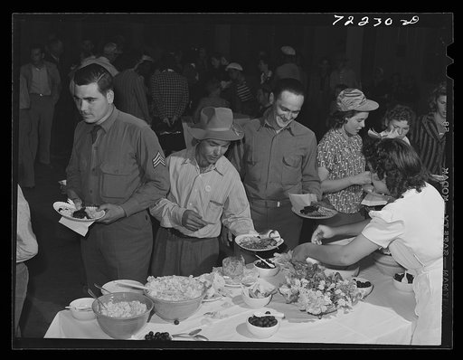 Farm workers at dinner at the second annual field day  at the FSA (Farm Security Administration) farm workers' community. Yuma, Arizona