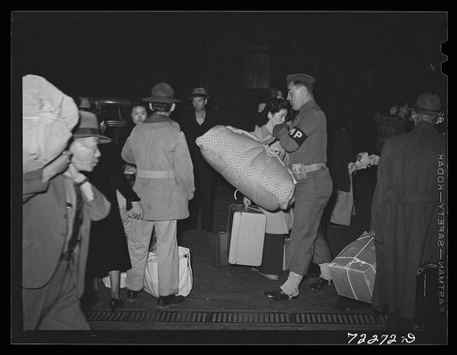 Los Angeles, California. The evacuation of Japanese-Americans from West coast areas under United States Army war emergency order. Soldiers assist Japanese with their baggage as they leave for Owens Valley