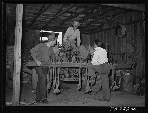 Los Angeles County, California. The evacuation of Japanese and Japanese-Americans from West coast areas, under United States Army war emergency order. Farmer inspecting farm equipment which Japanese farmer wants to sell before he is evacuated