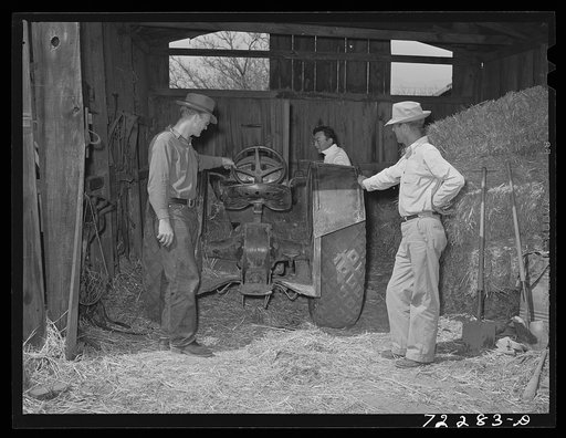 Los Angeles County, California. The evacuation of Japanese and Japanese-Americans from West coast areas, under United States Army war emergency order. Farmer inspecting farm equipment which Japanese farmer wants to sell before he is evacuated