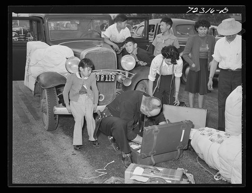 Los Angeles County, California. The evacuation of Japanese and Japanese-Americans from the West coast areas under Army war emergency order. Baggage of Japanese being examined on their arrival at the Santa Anita reception center