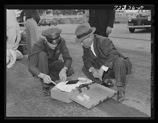 Santa Anita reception center, Los Angeles County, California. The evacuation of Japanese and Japanese-Americans from West coast areas under United States Army war emergency order. Examining baggage of Japanese as they arrive at the center