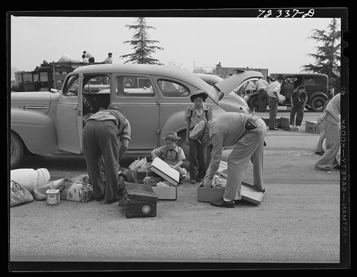 Santa Anita reception center, Los Angeles County, California. The evacuation of Japanese and Japanese-Americans from West coast areas under United States Army war emergency order. Examining baggage of Japanese as they arrive at the center