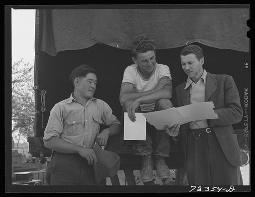 Los Angeles County, California. A representative of the FSA (Farm Security Administration) (right) talking with a farmer and a Japanese farmer. They are arranging for the white farmer to buy certain farm equipment, rent land, etc. of the Japanese who is subject to evacuation from the West Coast area
