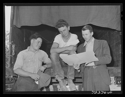 Los Angeles County, California. The evacuation of Japanese-Americans from West coast areas under United States Army war emergency order. FSA (Farm Security Administration) representative (right) talking with two farmers, one white and one Japanese. They are discussing the sale of the farm equipment,