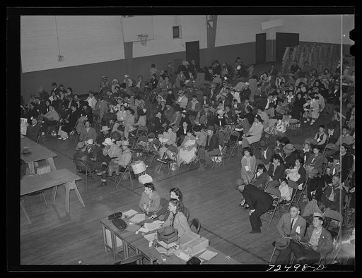 Salinas, California. Japanese-Americans waiting for transportation to the reception center for persons being evacuated from certain West coast areas under United States Army war emergency order