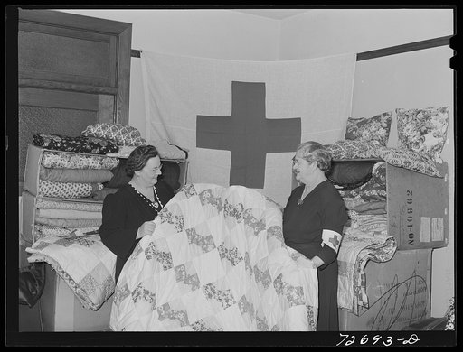 Turlock, California. Housewife (left) with some of the quilts the PTA (Parent Teacher Association) has made for the Red Cross. She is president of PTA