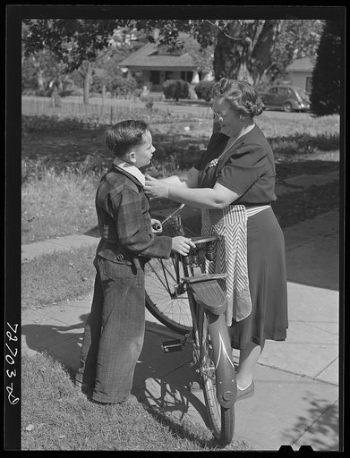Turlock, California. Housewife sending her son off to school