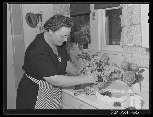 Turlock, California. Housewife arranging flowers in her kitchen