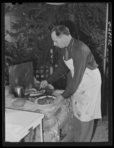 Turlock, California. Man of the house barbecues steaks over open grill