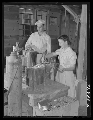 Turlock, California. Putting inert gas into cans of dehydrated cabbage which will be hermetically sealed
