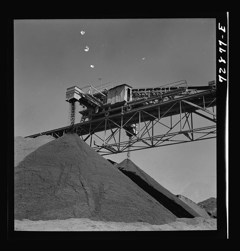 Shasta Dam, Shasta County, California. Pile of gravel under conveyor belt. The gravel will be used in construction of the dam