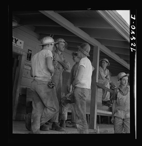 Untitled photo, possibly related to: Shasta Dam, Shasta County, California. Workman on the porch of the commissary