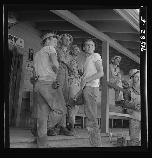 Shasta Dam, Shasta County, California. Workman on the porch of the commissary