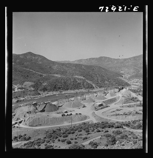 Shasta Dam, Shasta County, California. Piles of gravel and sandwhich arrive by conveyor belt at construction site of dam