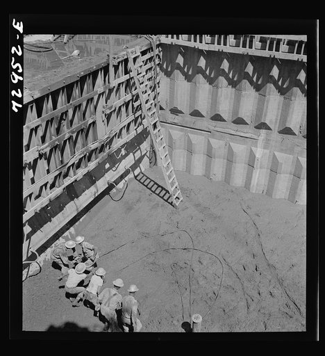 Shasta Dam, Shasta County, California. Vibrating newly-poured concrete at the dam to remove excess air and assure even settling