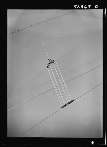 Shasta Dam, Shasta County, California. Cable carriage. Materials used in construction of the dam are carried to the exact construction site by cable cars or buckets which are strung from a central tower to several tail towers