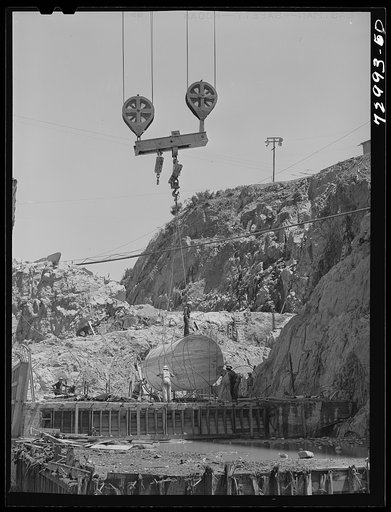 Shasta Dam, Shasta County, California. Lowering a sump into bottom of the dam