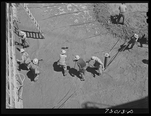 Shasta Dam, Shasta County, California. Workmen apply grout, a thin concrete mixture which is applied over previously poured mass of concrete