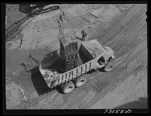 Untitled photo, possibly related to: Shasta Dam, Shasta County, California. Steam shovel dumps dirt into dumptruck