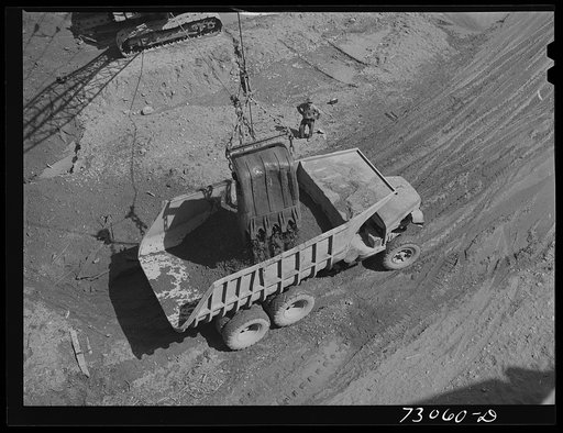 Shasta Dam, Shasta County, California. Steam shovel dumps dirt into dumptruck