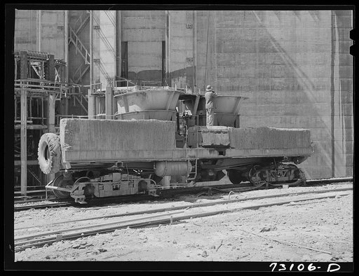 Shasta Dam, Shasta County, California. This car, which is filled with concrete at concrete mixing depot, runs on circular tracks to point where cable buckets are filled and transported to construction sites