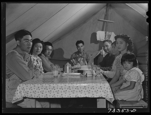 Untitled photo, possibly related to: Nyssa, Oregon. FSA (Farm Security Administration) mobile camp. Japanese mother and father with their American-born children in tent-home. One of the sons of this family is in the United States Army. Two of the sons were studying engineering at an American univers